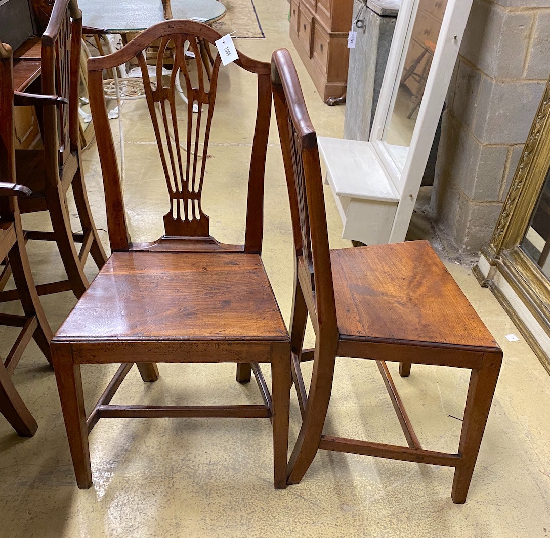 A set of four George III Provincial fruit wood solid seat dining chairs